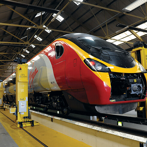 alstom-operational-excellence-supports-growth-strategy-banner-1 High-speed Virgin train in maintenance depot representing Alstom operational excellence and growth strategy.